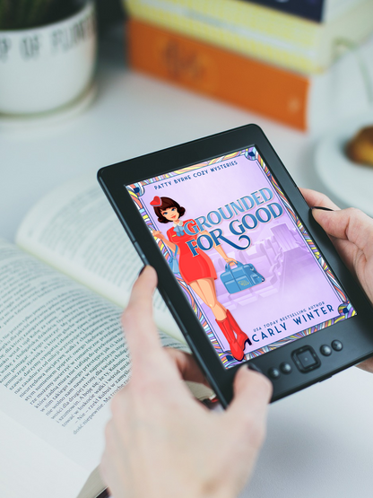 Woman reading Grounded for Good historical cozy mystery on a tablet