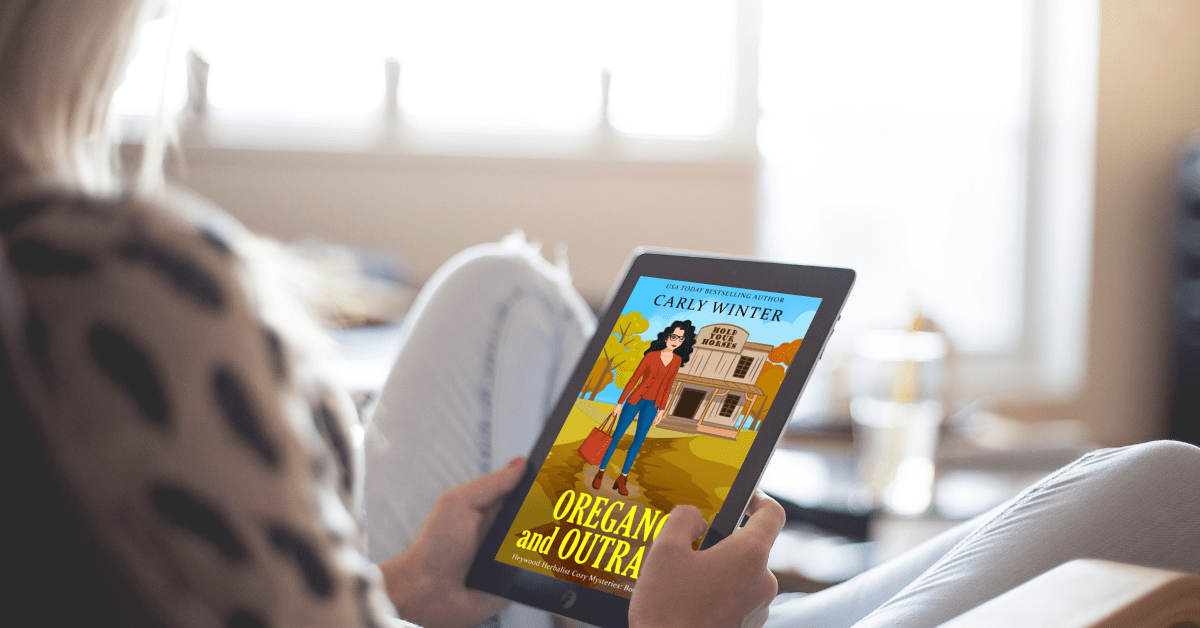 woman reading oregano and outrage by carly winter on an ereader