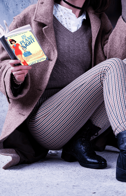 Reader enjoying In plane sight paperback by carly winter