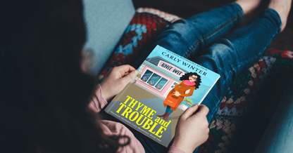 Woman reading Thyme and Trouble paperback by Carly Winter 