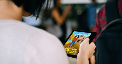 pretty woman reading oregano and outrage by carly winter on an ereader
